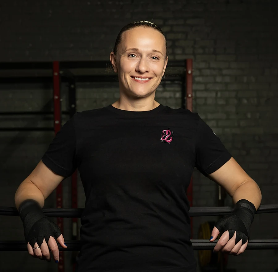 Carmen &ldquo;The Momba&rdquo; Gulliksen at the gym in a Momba shirt and hand wraps