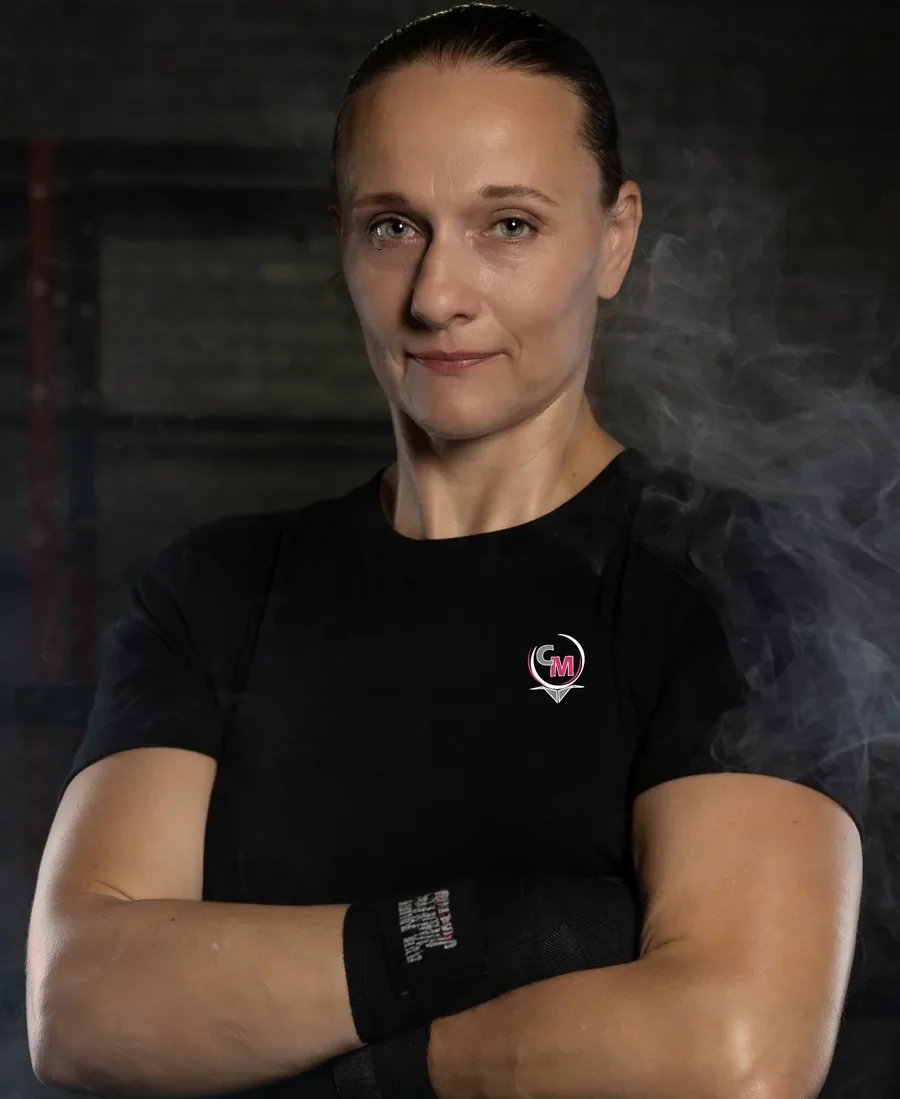 Carmen &ldquo;The Momba&rdquo; Gulliksen, arms crossed, in a Momba shirt